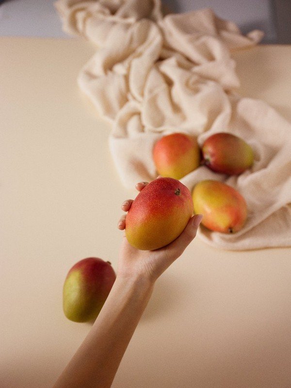 Hand holding a mango